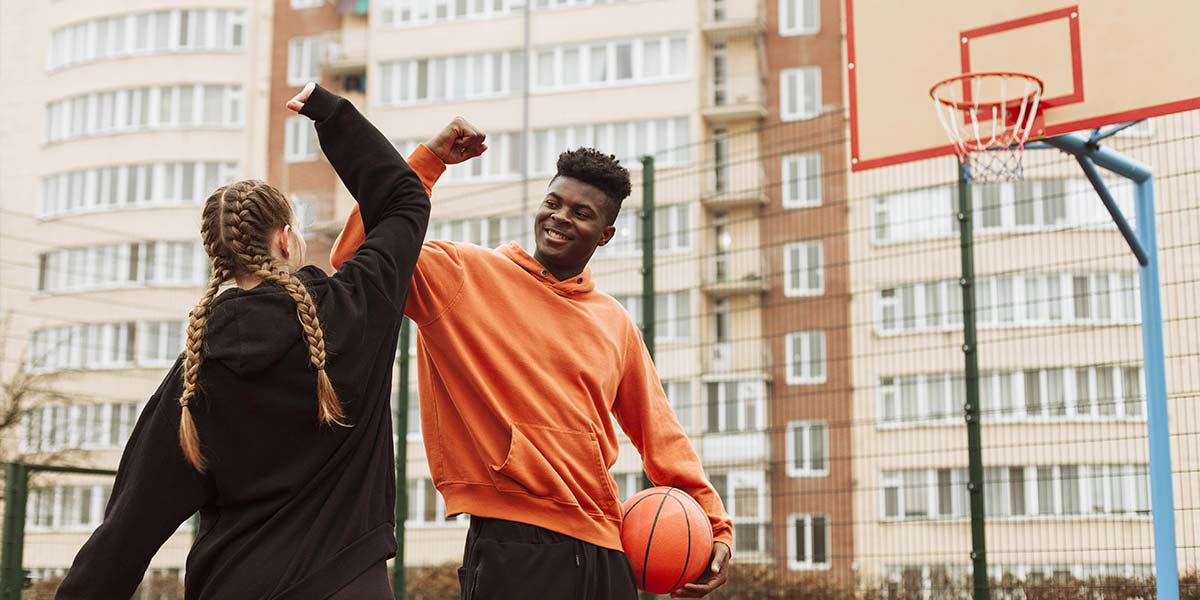 Teenager playing basketball together